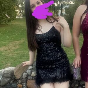 Black dress with feathers at bottom and very unique and beautiful design